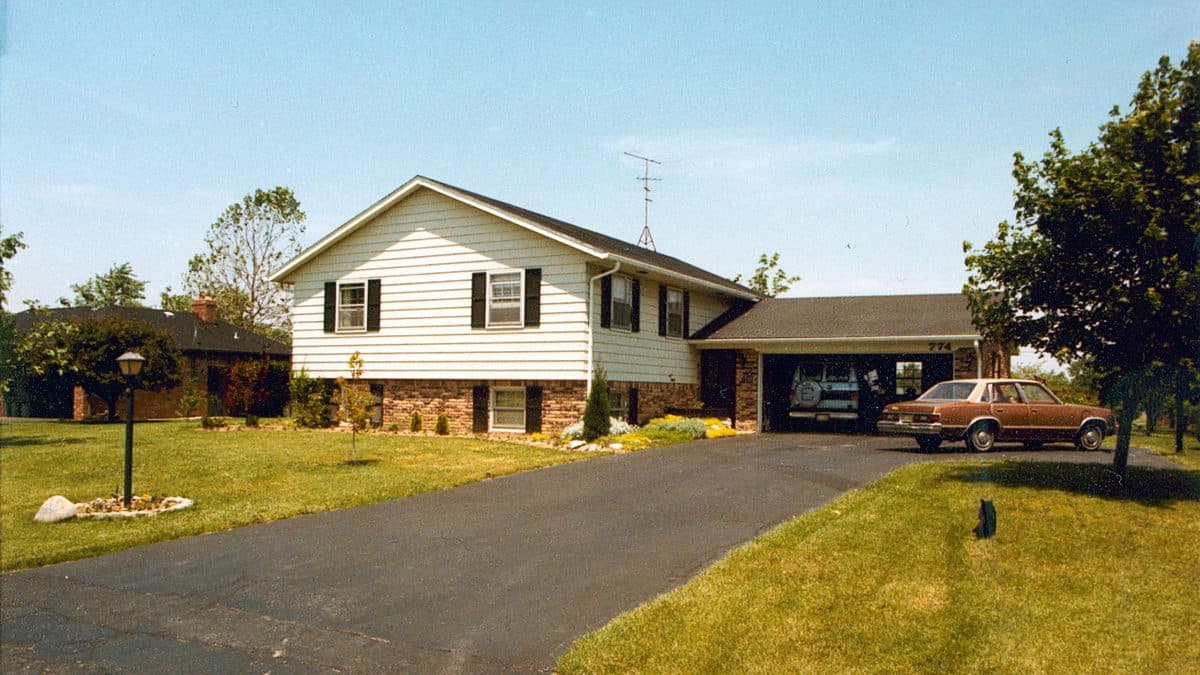 A mowed turf grass lawn in front of a house