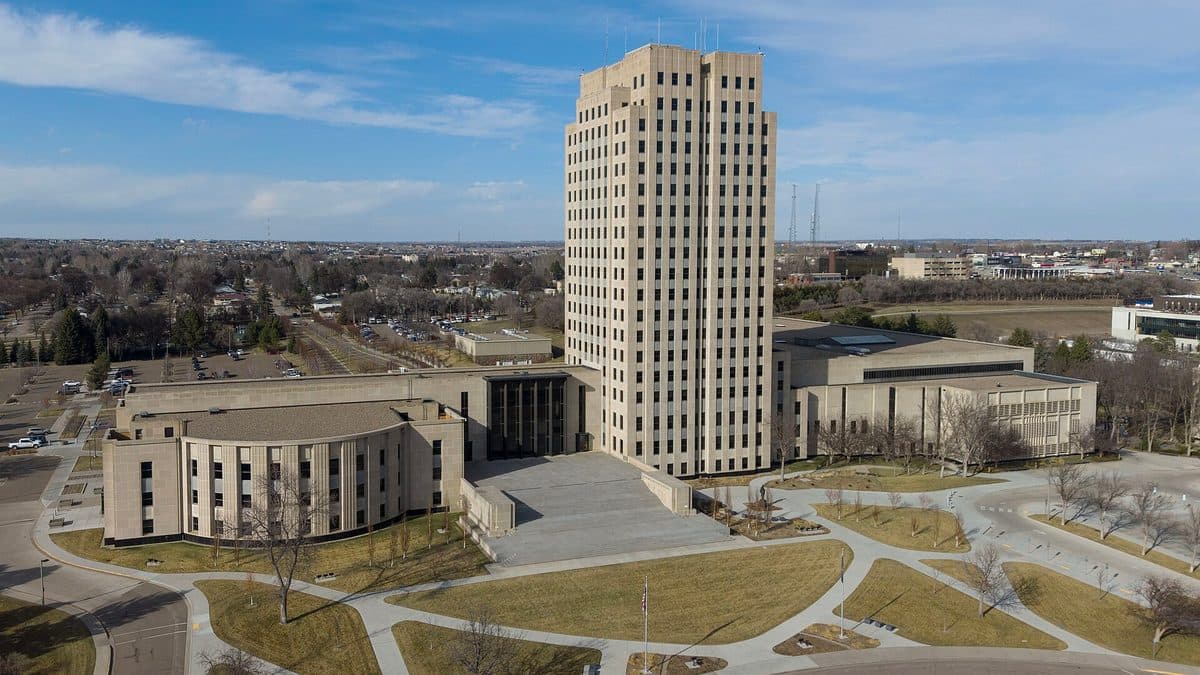 The tower of the North Dakota State Capitol with its low wings and lawns, seen from above